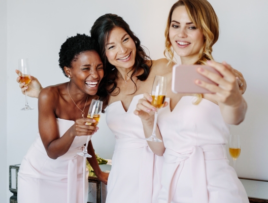 Beautiful bridesmaids taking selfie