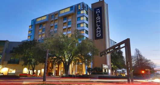 Exterior building of The Highland Dallas at night.