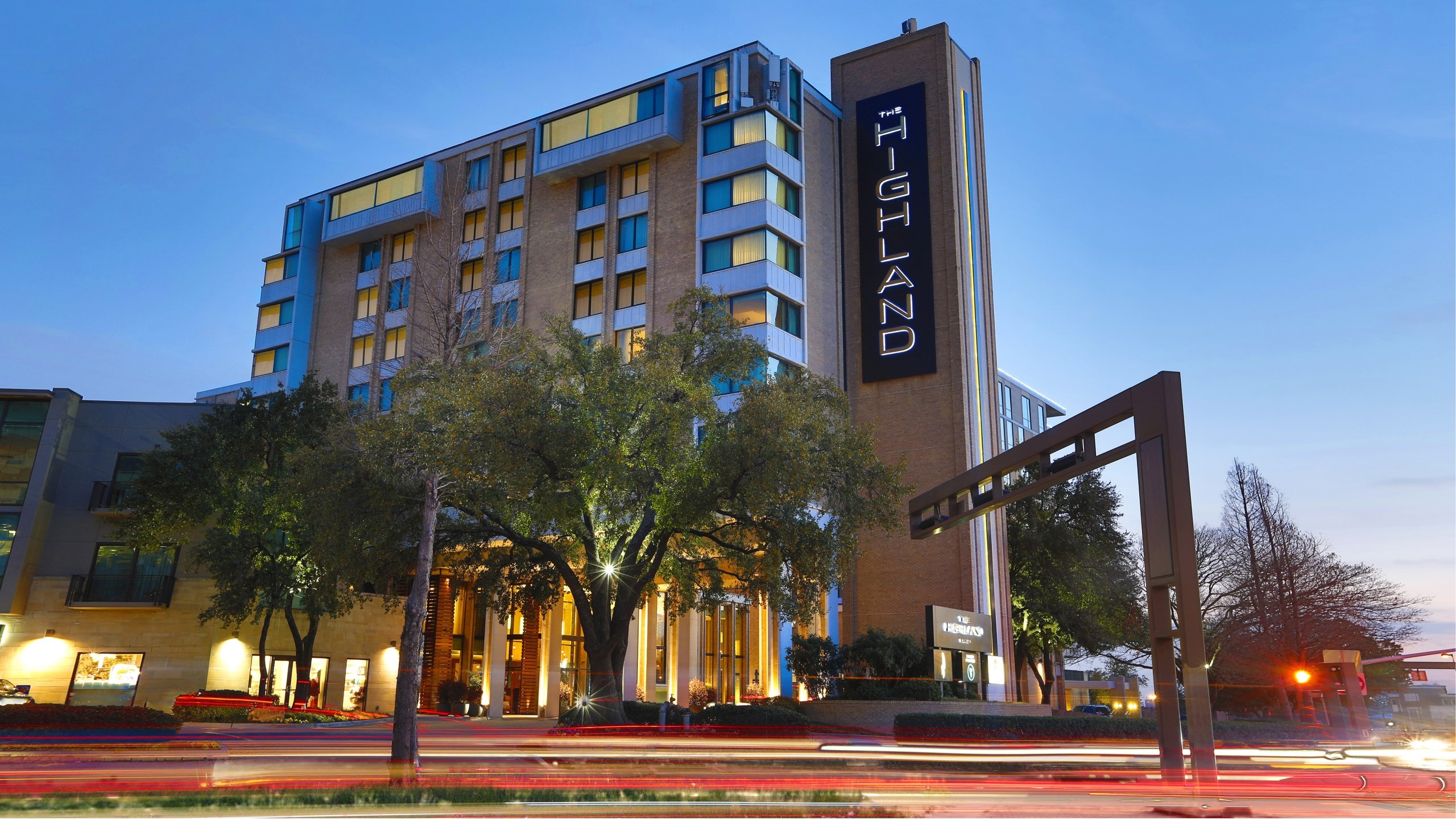 Exterior building of The Highland Dallas at night.